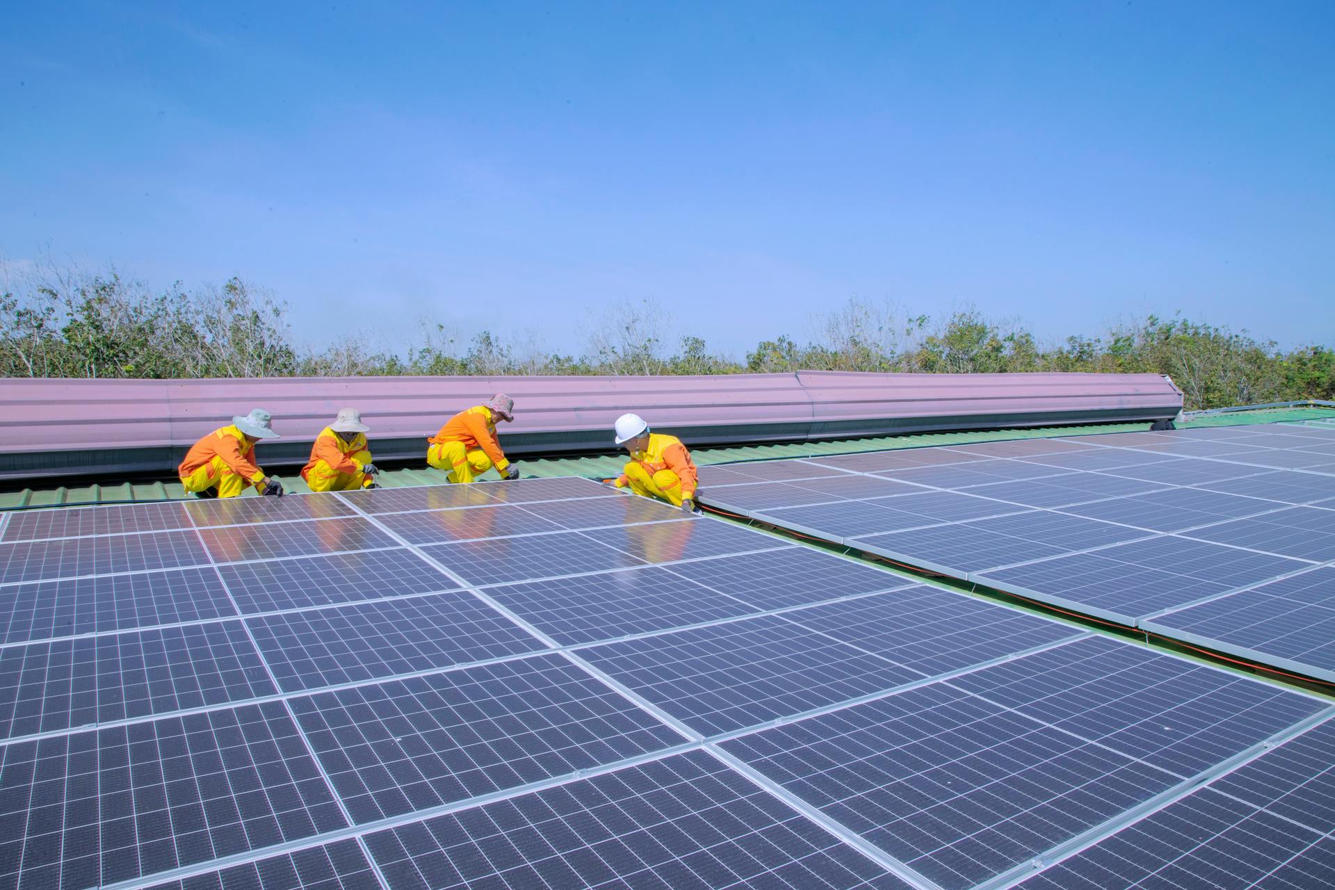 High-efficiency solar panels on a rooftop under a clear blue sky
